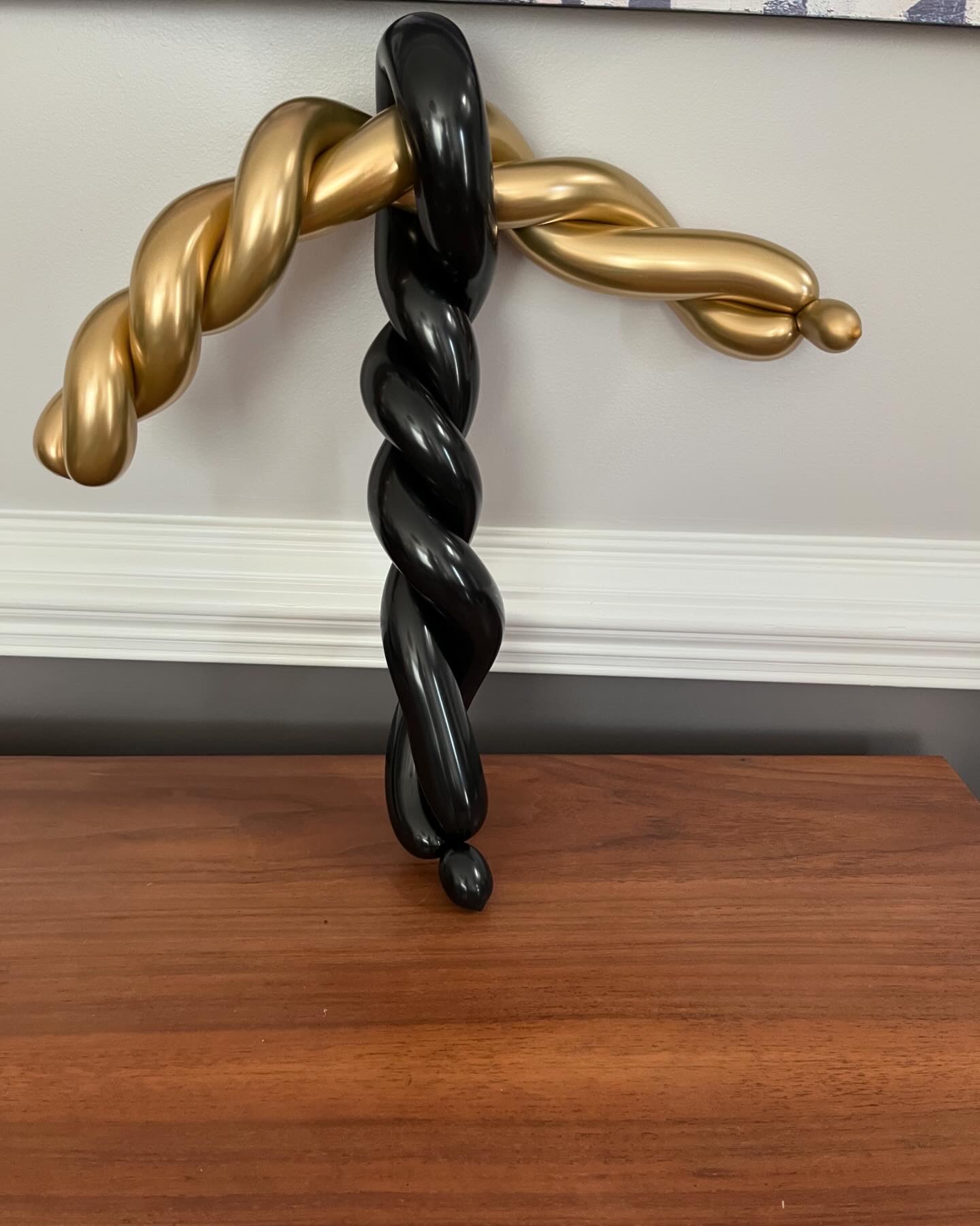 Twisted gold and black balloon sculpture