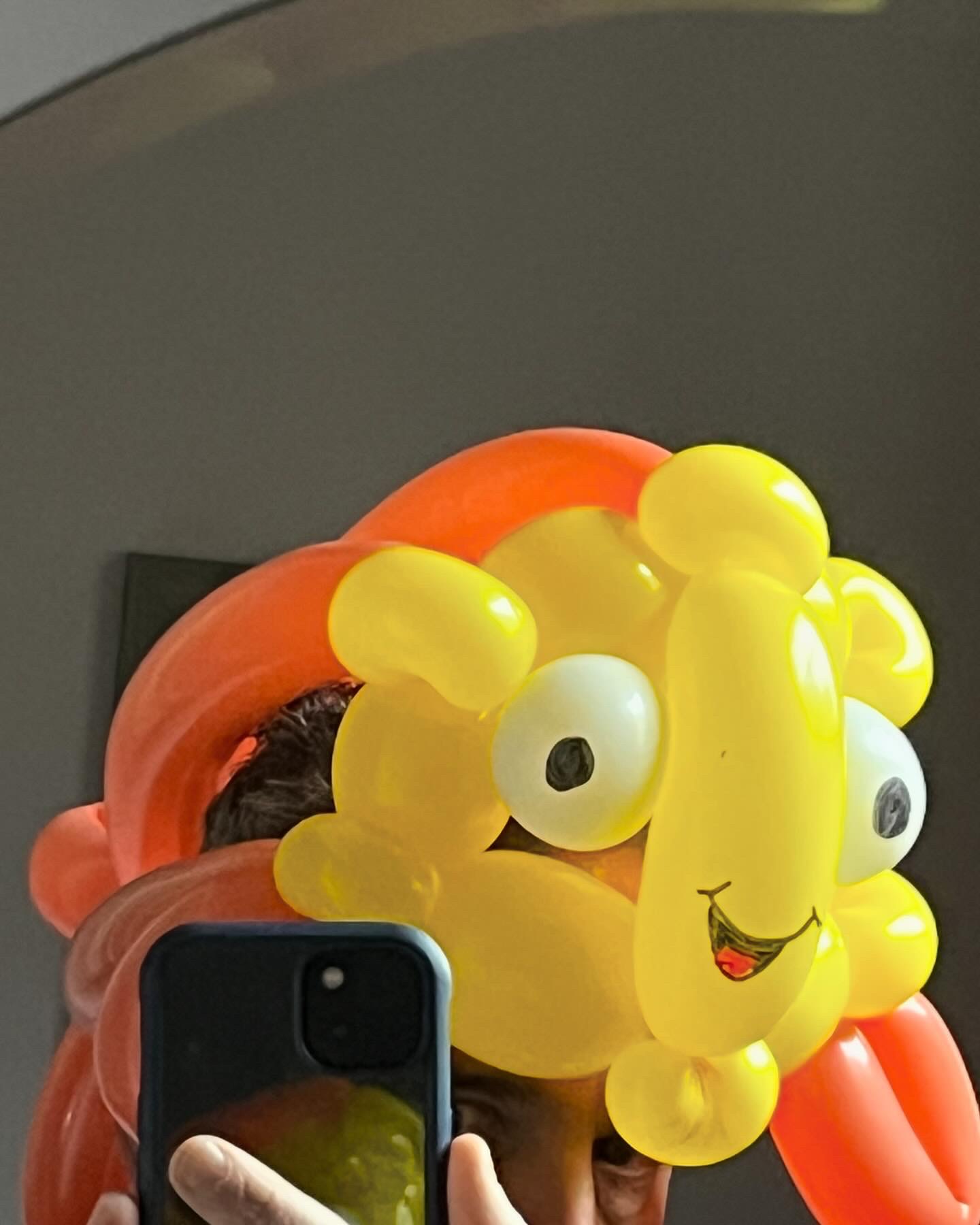 Wearable yellow and orange balloon lion hat